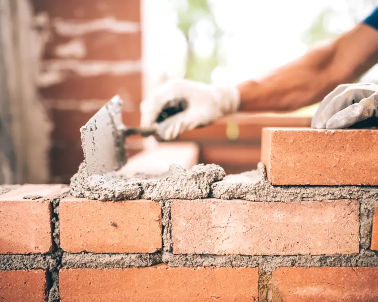 bigstock-Bricklayer-Worker-Installing-B-141056804