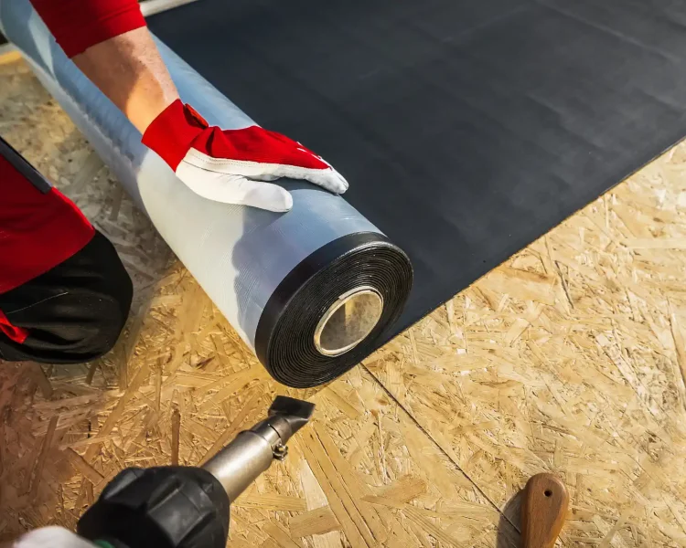 bigstock-Roof-Worker-With-Roll-Of-Epdm--476219159